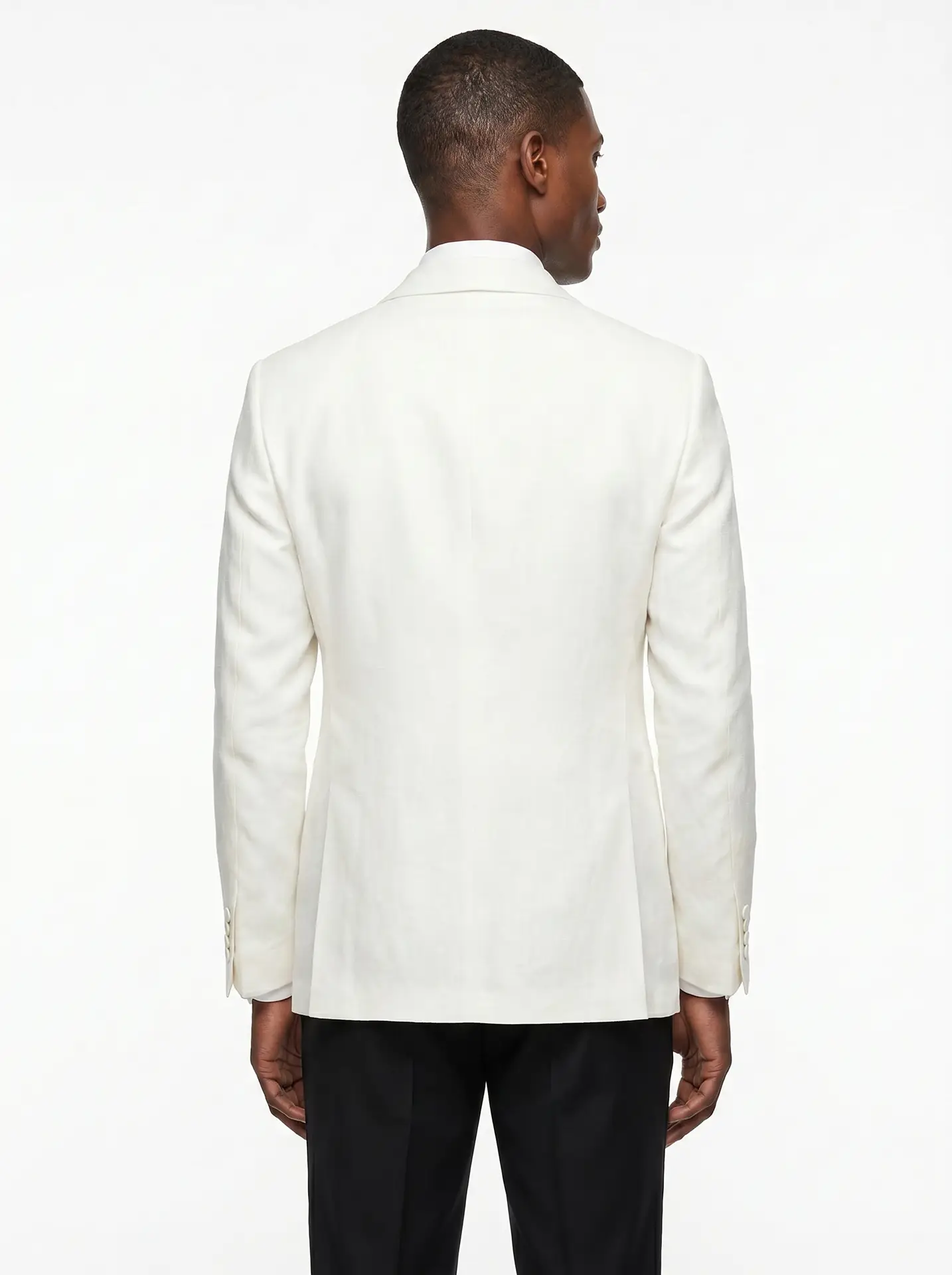 Back view of a men's ivory shawl-lapel dinner jacket with black trousers, slim-fit tuxedo - Black Jacket Suiting Brisbane