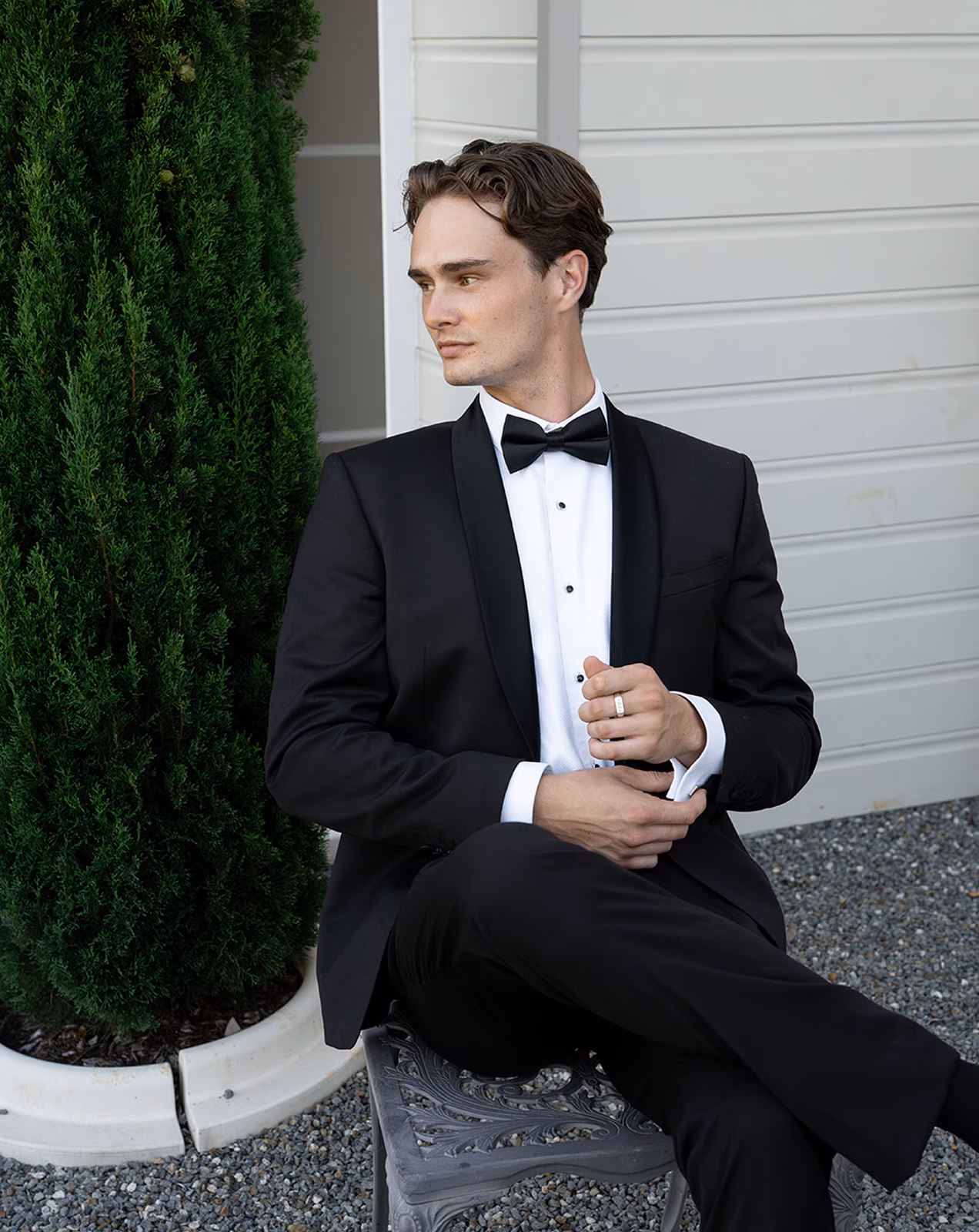 Man in Tuxedo Suit by Black Jacket Suiting in Brisbane Sitting Outside